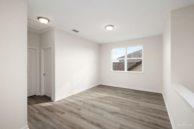 spare room with dark hardwood / wood-style flooring