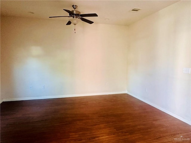 unfurnished room featuring ceiling fan and dark wood-type flooring