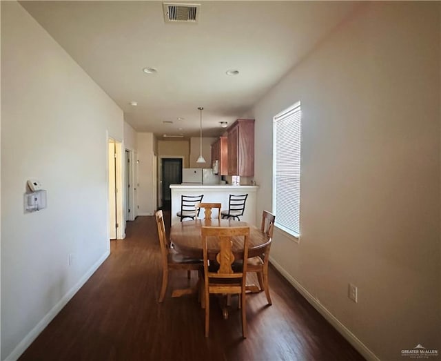 dining room featuring dark hardwood / wood-style flooring