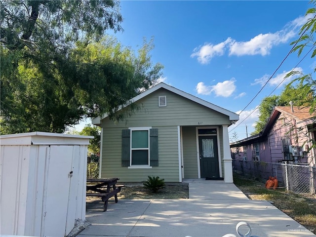 view of front of house with a storage shed