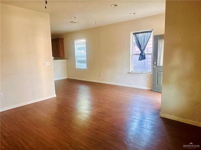 spare room with dark hardwood / wood-style flooring