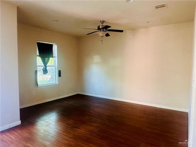 spare room with ceiling fan and dark wood-type flooring