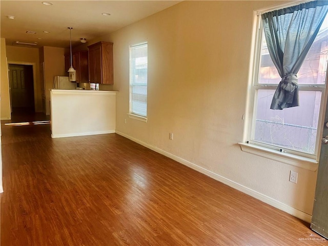 unfurnished living room with dark hardwood / wood-style floors