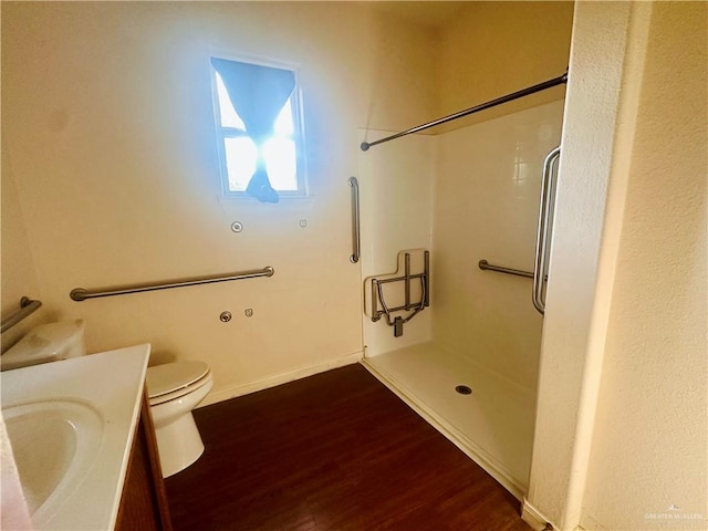 bathroom featuring hardwood / wood-style flooring, vanity, toilet, and walk in shower