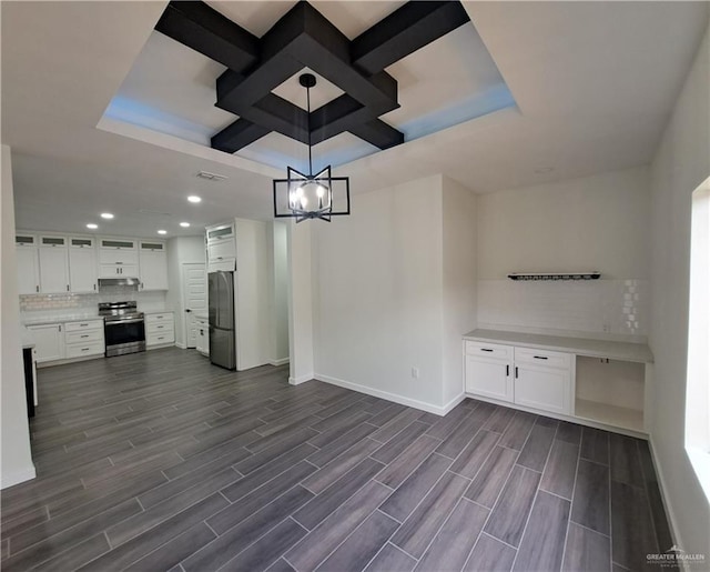 708 E 3rd Ave, Elsa, TX 78543 - unfurnished living room with baseboards, dark wood-style floors, recessed lighting, a chandelier, and a raised ceiling
