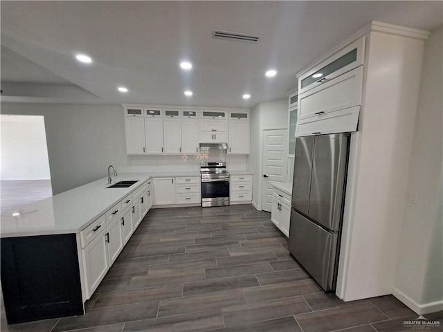 708 E 3rd Ave, Elsa, TX 78543 - kitchen with appliances with stainless steel finishes, a sink, recessed lighting, wood finish floors, and tasteful backsplash