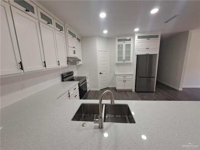 708 E 3rd Ave, Elsa, TX 78543 - kitchen featuring black range with electric stovetop, built in refrigerator, a sink, white cabinetry, and recessed lighting