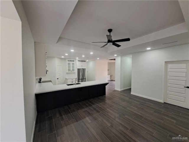 708 E 3rd Ave, Elsa, TX 78543 - kitchen featuring freestanding refrigerator, dark wood-style flooring, baseboards, recessed lighting, and a raised ceiling