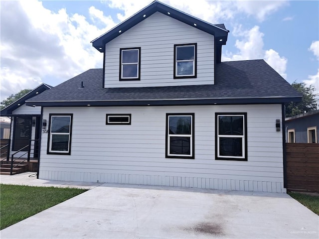 708 E 3rd Ave, Elsa, TX 78543 - rear view of property featuring a shingled roof and a patio