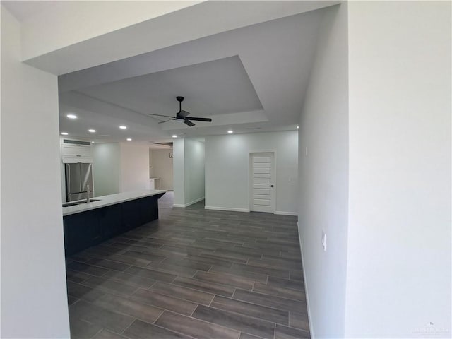 708 E 3rd Ave, Elsa, TX 78543 - unfurnished living room featuring a ceiling fan, recessed lighting, baseboards, and wood finish floors