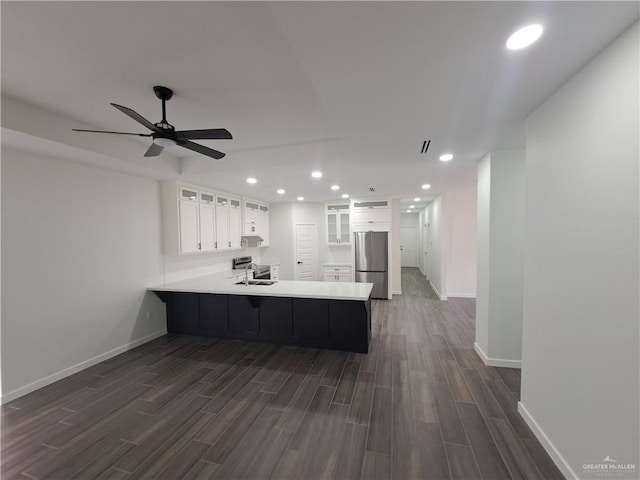 708 E 3rd Ave, Elsa, TX 78543 - kitchen with stainless steel fridge, a peninsula, dark wood finished floors, a sink, and baseboards