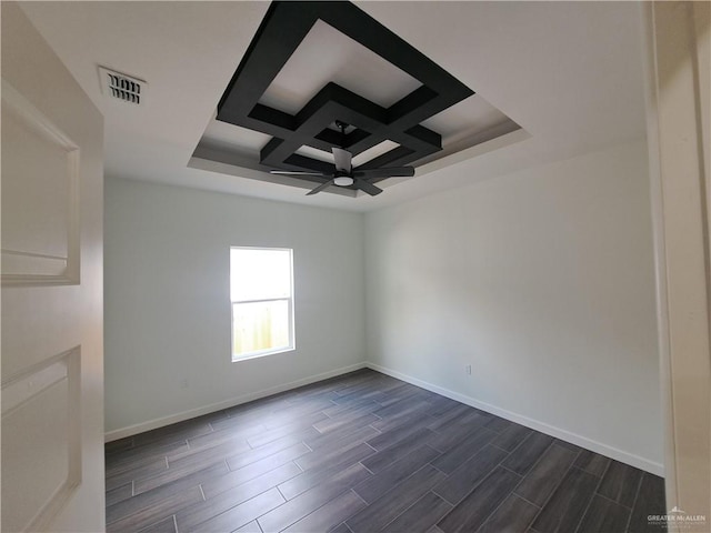 708 E 3rd Ave, Elsa, TX 78543 - unfurnished room with dark wood finished floors, baseboards, ceiling fan, coffered ceiling, and beamed ceiling