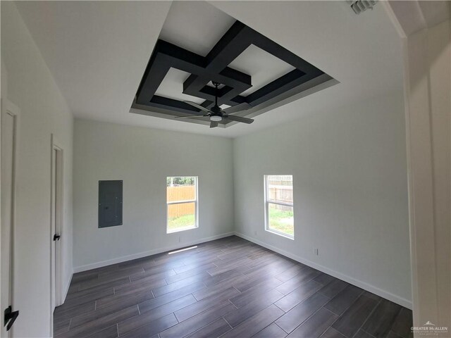 708 E 3rd Ave, Elsa, TX 78543 - spare room with electric panel, ceiling fan, coffered ceiling, baseboards, and dark wood-type flooring