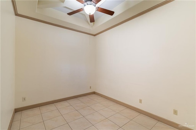 tiled spare room featuring ceiling fan, a raised ceiling, and crown molding