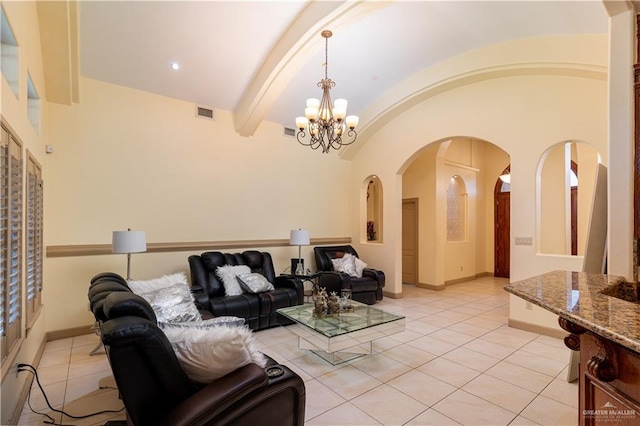 living room featuring a chandelier, light tile patterned floors, and lofted ceiling with beams