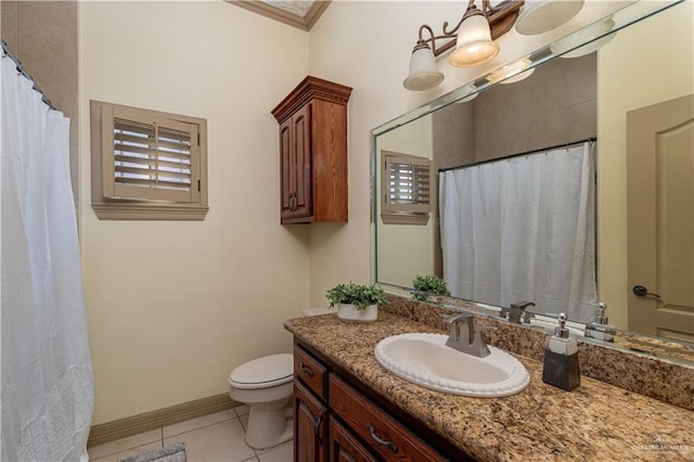 bathroom featuring tile patterned flooring, vanity, toilet, and crown molding