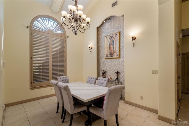 tiled dining room with an inviting chandelier