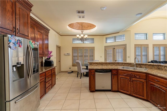 kitchen featuring plenty of natural light, sink, stainless steel appliances, and a chandelier