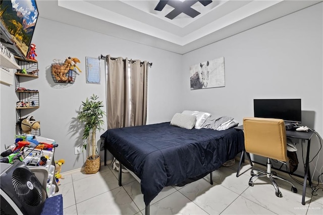 bedroom featuring a tray ceiling and ceiling fan