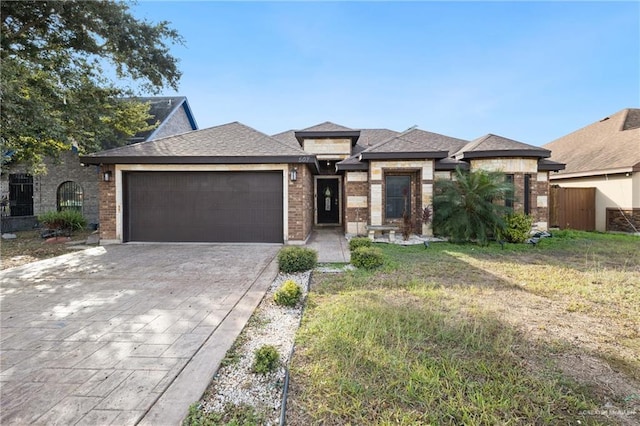 view of front of property with a garage and a front lawn