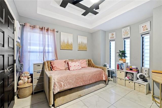 bedroom featuring a tray ceiling and ceiling fan