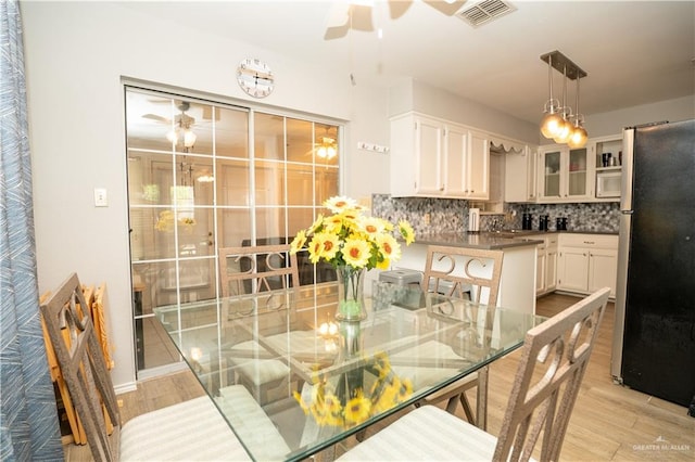 dining area featuring light hardwood / wood-style floors and ceiling fan