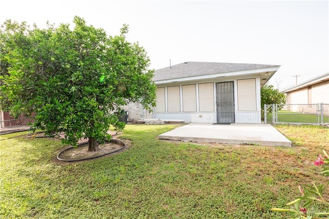 back of property featuring a lawn and a patio