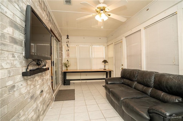 living room with ceiling fan and light tile patterned floors