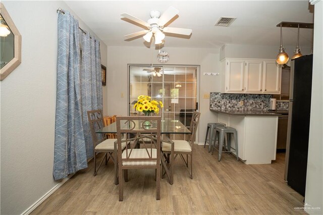 dining room featuring ceiling fan and light hardwood / wood-style flooring