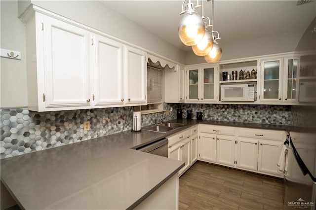 kitchen with white cabinets, pendant lighting, decorative backsplash, and range