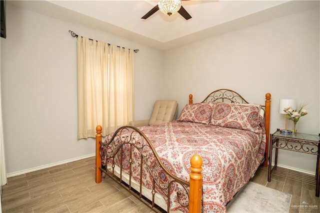 bedroom with wood-type flooring and ceiling fan