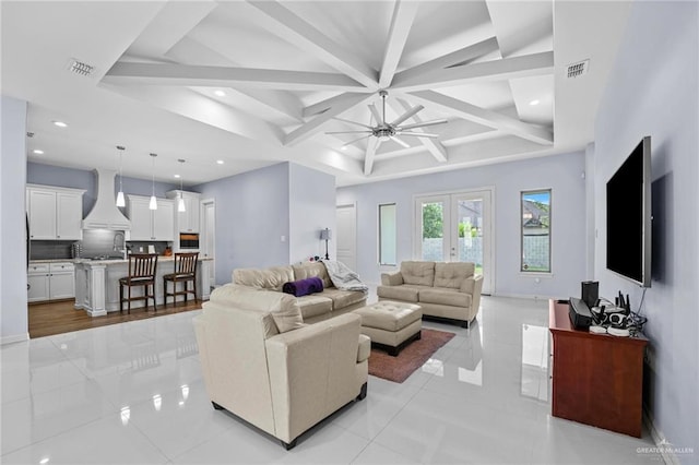 tiled living room with french doors, ceiling fan, and beam ceiling