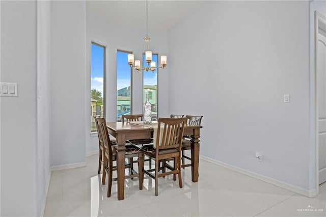 tiled dining room featuring an inviting chandelier