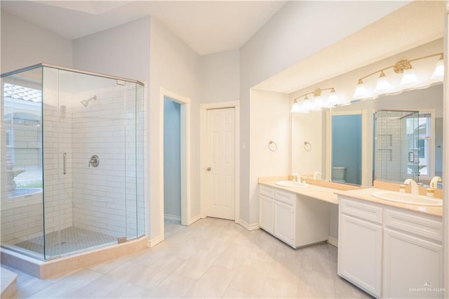 bathroom with tile patterned flooring, a shower with door, and vanity