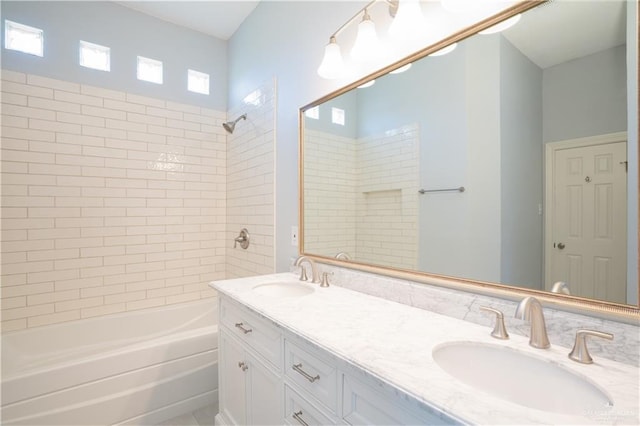 bathroom featuring vanity and tiled shower / bath combo