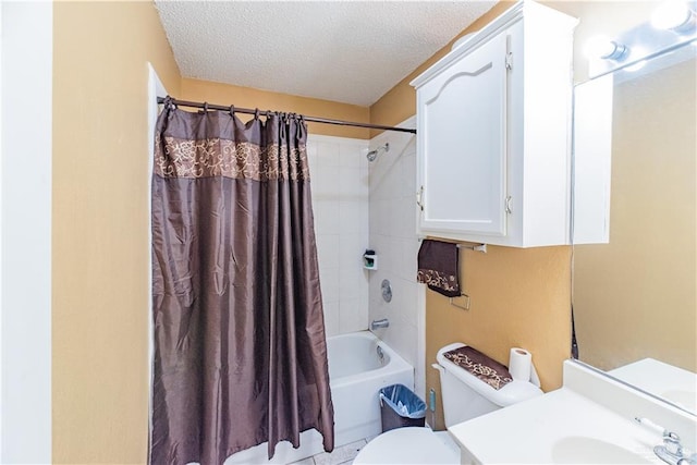 full bathroom featuring shower / bath combo with shower curtain, vanity, a textured ceiling, and toilet