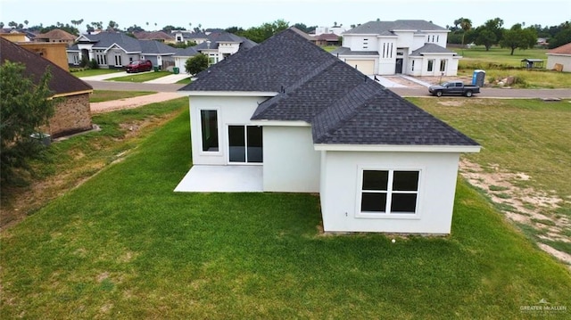 1209 Rhett Dr, Pharr, TX 78577 - rear view of house featuring roof with shingles, a residential view, stucco siding, and a lawn