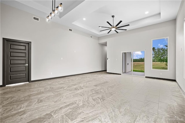 1209 Rhett Dr, Pharr, TX 78577 - unfurnished living room with a raised ceiling, ceiling fan, baseboards, light marble finish floors, and recessed lighting