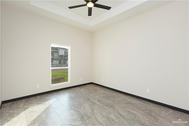 1209 Rhett Dr, Pharr, TX 78577 - unfurnished room with ceiling fan, baseboards, and a tray ceiling