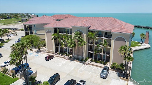 310 E Houston St Unit 1403, Port Isabel, TX 78578 - view of building exterior with uncovered parking and a water view
