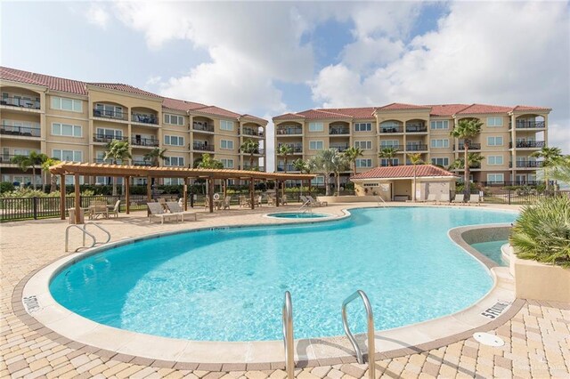 310 E Houston St Unit 1403, Port Isabel, TX 78578 - community pool with fence, a hot tub, and a patio