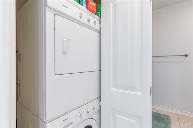 310 E Houston St Unit 1403, Port Isabel, TX 78578 - laundry area featuring estacked washer and dryer, light tile patterned floors, and baseboards