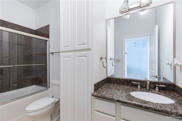 310 E Houston St Unit 1403, Port Isabel, TX 78578 - full bathroom featuring toilet, vanity, and bath / shower combo with glass door