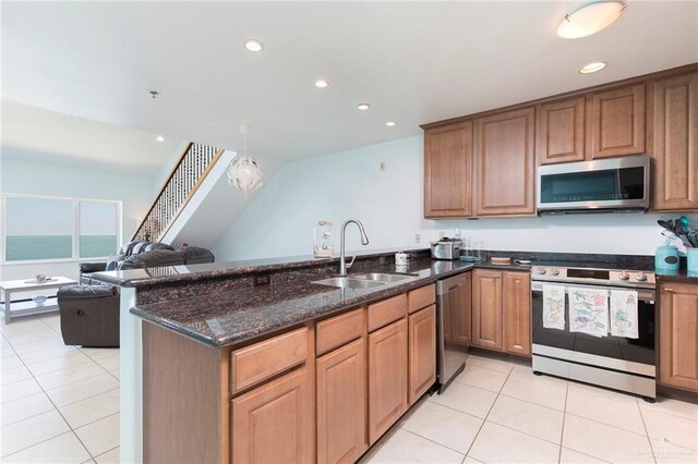 310 E Houston St Unit 1403, Port Isabel, TX 78578 - kitchen featuring appliances with stainless steel finishes, a sink, recessed lighting, light tile patterned floors, and dark stone counters