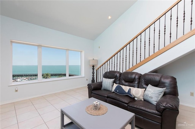 310 E Houston St Unit 1403, Port Isabel, TX 78578 - living area featuring tile patterned floors, baseboards, recessed lighting, stairs, and a water view