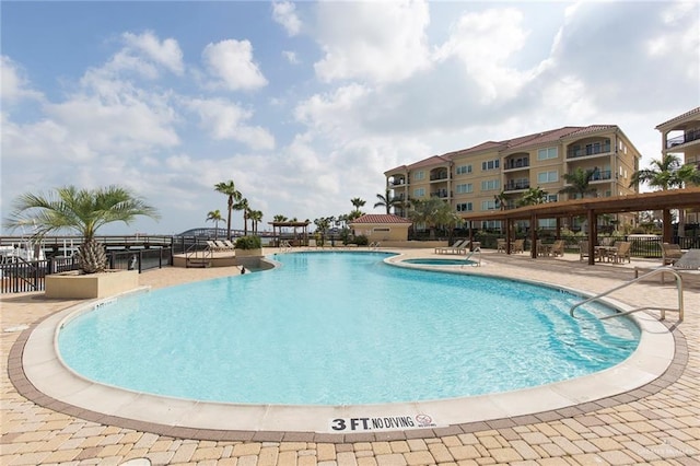 310 E Houston St Unit 1403, Port Isabel, TX 78578 - community pool featuring a community hot tub, fence, and a patio
