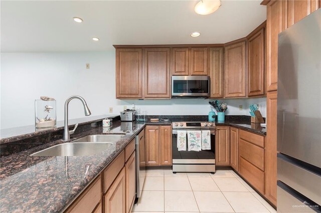 310 E Houston St Unit 1403, Port Isabel, TX 78578 - kitchen with appliances with stainless steel finishes, a sink, light tile patterned floors, brown cabinets, and recessed lighting