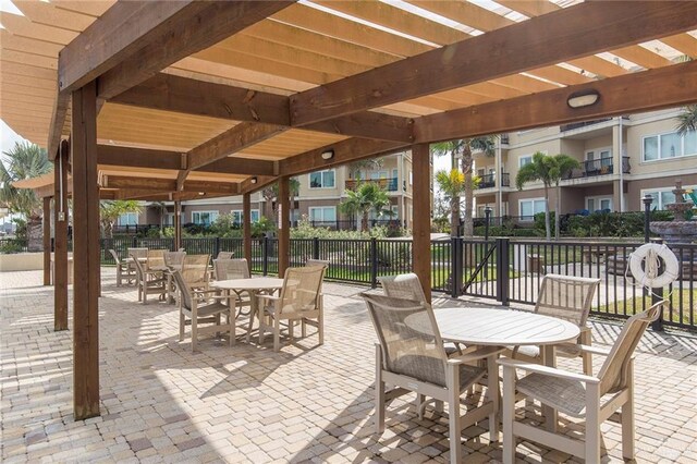 310 E Houston St Unit 1403, Port Isabel, TX 78578 - view of patio / terrace featuring outdoor dining space, fence, and a pergola