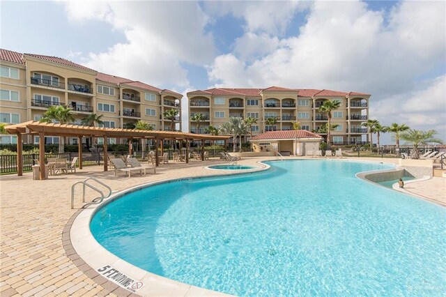 310 E Houston St Unit 1403, Port Isabel, TX 78578 - community pool with a community hot tub, fence, and a patio