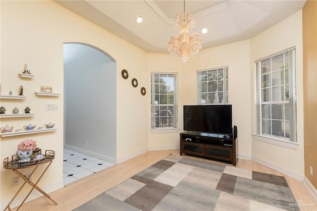 3305 W San Luis Cir, Mission, TX 78573 - living area featuring arched walkways, wood finished floors, a chandelier, recessed lighting, and baseboards